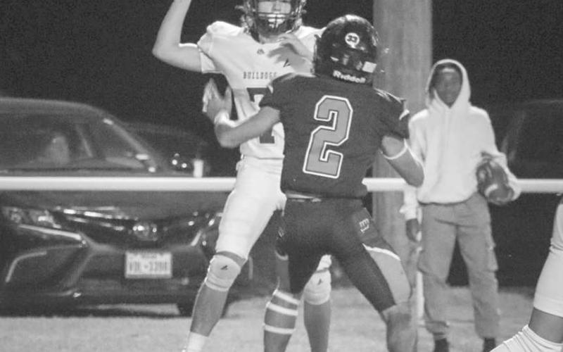UNDER PRESSURE - Anton Bulldog Caleb Carlock threw the ball to his checkdown after Whitharral Panther Daniel Rodriguez was there to pressure him this past Friday night. (Staff photo by Aalijah Soliz)