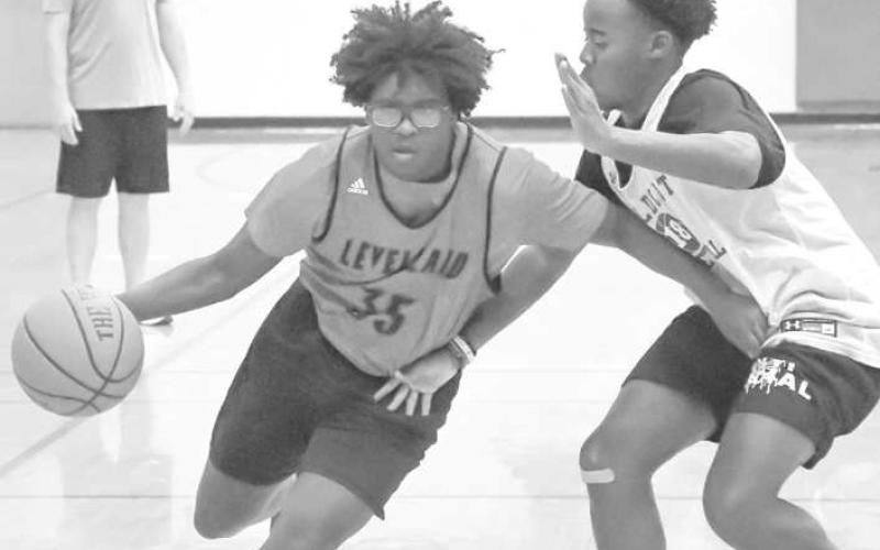 DRIVING- The Levelland Lobos hosted Littlefield and Canyon is exhibition matches Thursday at Levelland Middle School. Pictured driving to the basket is Lobo Tra Holland. (Staff Photo by Aalijah Soliz)