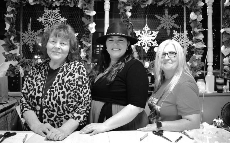 SERVING UP SMILES - Sandra Cowan, Ashley Tessneer &amp;amp; Petra Harding took a small break from a busy evening during the Ladies Night Out event held in downtown Levelland. The event is put on through the Main Street program every year. Several downtown businesses took part in the event. (Photo courtesy of Delany Jackson)