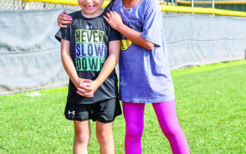 FRIENDS AT SOFTBALL CAMP - Margaret Favor and Aariyah Ramirez had fun improving their softball skills at the Loboette Softball Clinic on May 29. (Staff photo by Hannah Woodrum)