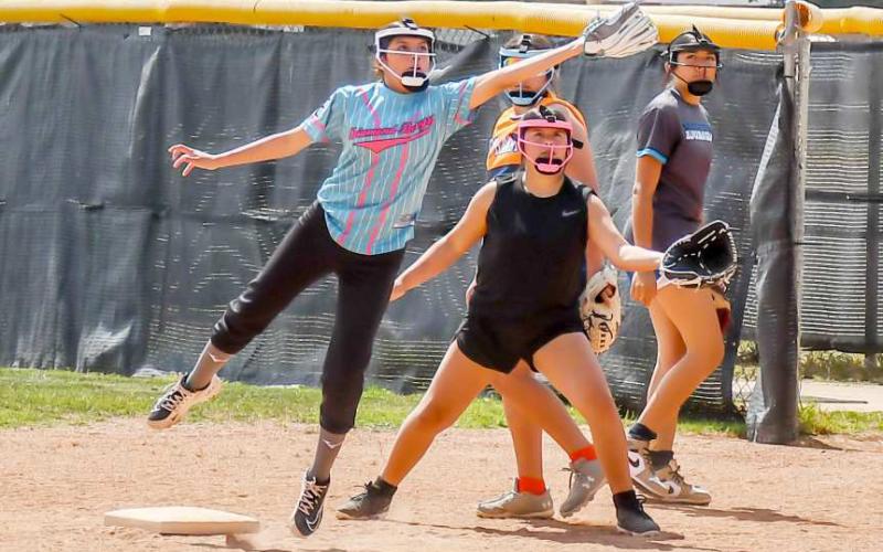 MAKINGA PLAY - Pictured is A’naliyah Escabar making a leaping catch at first at the Loboette Softball Field during their annual summer clinic held May 29. (Staff photo by Hannah Woodrum)