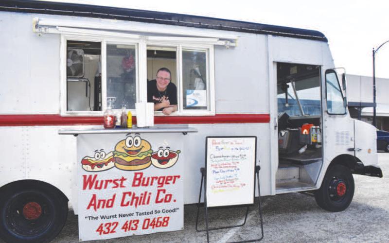 BURGER TRUCK – Pictured is Kevin Jones in his truck on Thursday. Every third Thursday from March to September, food trucks come to the square offering a variety of choices for lunch. (Staff photo by Ada Niederhauser)