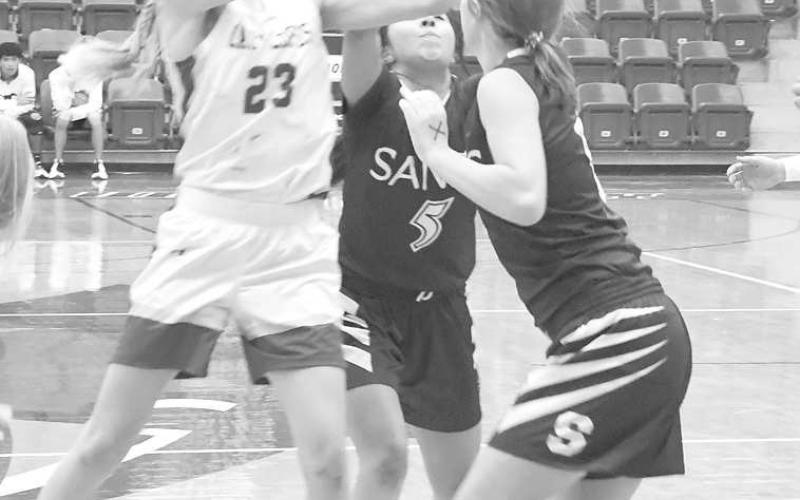 FIRST TIE- Whiteface’s Allison Martha fought for a rebound against two Sands Lady Stangs in a 41-38 overtime win over the Lady Stangs in the UIL Girls High School Class 1A Regional Quarterfinals at the Rip Griffin Center on the campus of Lubbock Christian University last Tuesday. Martha led the Lady Lopes with 12 points. (Photo Courtesy of Jay Kelley)