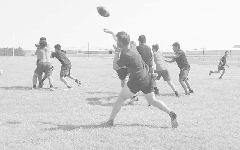 DEEP BALL - Levelland Lobo Rusty Johnson launches a deep ball to his receiver. Pictured above is Rusty Johnson behind his O-Line during summer worlouts. (Staff Photo by Aalijah Soliz)