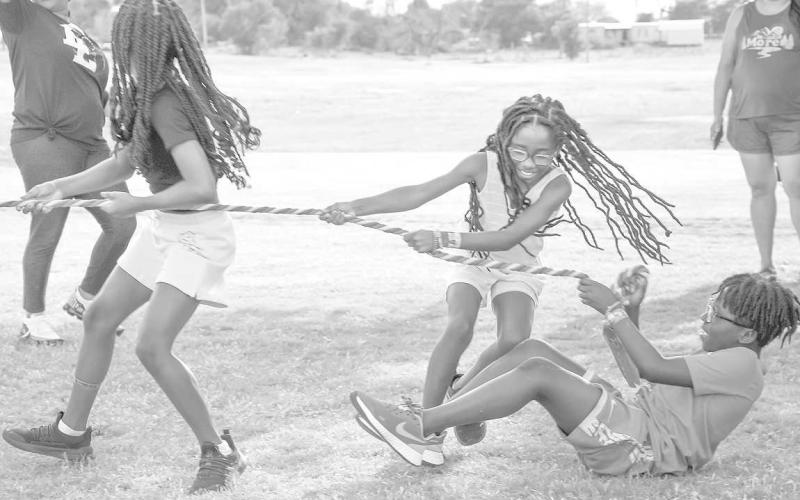 TUG OFWAR - Cadence Minor (LEFT), Camryn Minor (MIDDLE), Za’Kavian Childers (RIGHT) playing games during the Juneteenth celebration. There were many activities including bingo, dominoes, karaoke and a dance. (Staff Photo by Victoria Brynes)
