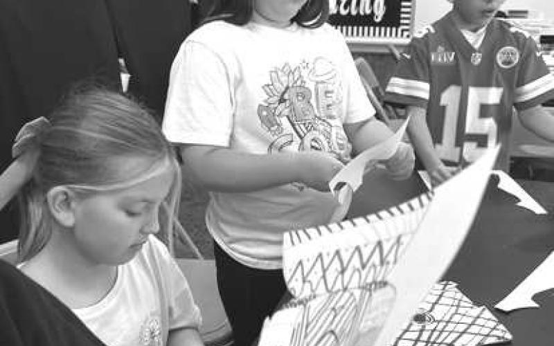 EASTER ART- Hippiti-Hoppity Easter’s on its way! South students were caught this week creating Easter art. They had to use their fine-motor skills for these small Bunnies. They had to use their math skills to show symmetry to the other Bunnies. South thanked Mrs. Bara for always engrossing kids in the most intriguing art activities. Pictured are: Trace Gavina, Jordan Brown (middle). (Photo courtesy of Cristal Isaacks)