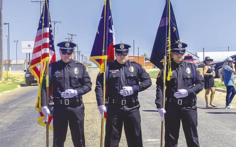 HONOR GUARD - The Levelland Police Department Honor Guard was present during the Thunder on the Plains Car Show at the Levelland City Park on Saturday morning. Pictured from left to right is: Officer Omar Diaz, Officer Emilio Miranda and Officer Ernest Hernandez holding their respective flag before the beginning of the annual burnout competition. The national anthem was sang by Martina McBride and prayer was offered by Justin Owens of the 5th Street Church.