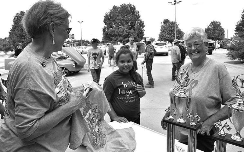THUNDER SWAG– Jazzi Dawson (middle) and her Nana, Sheila Farrar, were buying Thunder on the Plains swag from Cindy Reaves Friday night for the Poker Run. The annual Thunder on the Plains held its Poker Run and Cruise Friday evening followed by the Classic Car Show on Saturday. (Staff Photo)