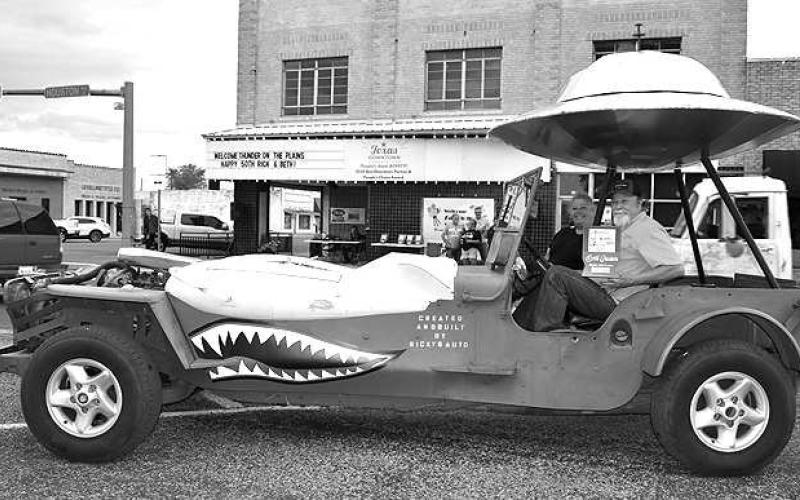 WE ARE NOT ALONE– Ricky and Karen Taylor of Shallowater, came to add some out of this world excitement to the annual Thunder on the Plains Poker Run and Cruise, with their 1946 Willy’s Jeep Rat Rod topped with an alien spacecraft. Ricky fabricated the spacecraft for his 11 grandchildren after a trip to Rowell. The spacecraft was fabricated from an old satalight dish and had rotating colored lights around the edge. They received a peoples choice award for Best Cruiser. (Staff Photo)