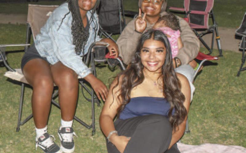 HANGING OUT - Pictured are Destinee Olivas, Zoe Jordan, Chloe Jordan who is holding Brexlee Golightly as they enjoyed their time at the annual Juneteenth Celebration at L.G. Griffin. The event included a car show, cookout, kid games and a basketball tournament. (Staff photo by Essence Childers)