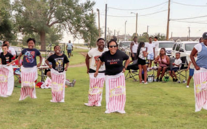 SACK RACES - Pictured are participants of the sack race that took place on Saturday during the local Juneteenth Celebration. Members of the community were able to eat and catch up with friends during the two-day event held at L.G. Griffin Park. (Staff photo by Essence Childers)