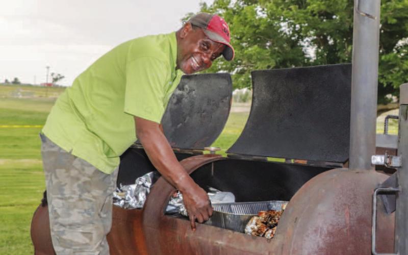 CHECKING THE MEAT - Willie Jones, member of the Juneteenth Committee was checking the meat during the annual Juneteenth Cookout. A cookout is held every year to commemorate the day the news of the Emancipation Proclamation making it to enslaved people in Texas. (Staff photo by Hannah Woodrum)