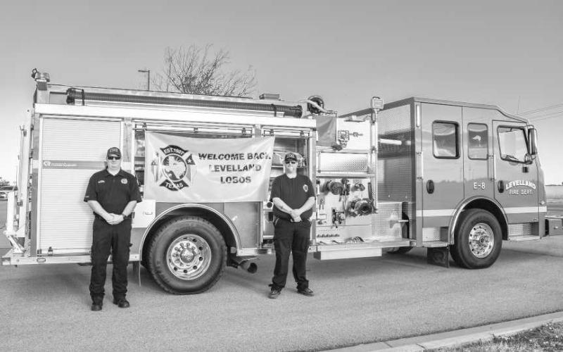The Levelland Fire Department participated in welcoming the LISD students back to school on Thursday. Pictured is Jeff Pharis and Cooper Madewell greeting and taking photos with the students in the LABC school parking lot. (Photo courtesy of Emily Campos)