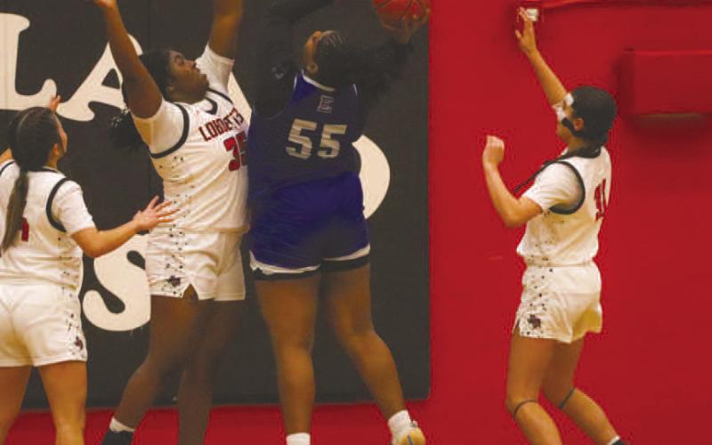 NOTAROUND HERE - Levelland Loboette Sydnii Joyce went vertical with the Estacado Center during the team’s game against each other for district play at home. (Staff photo by Aalijah Soliz)