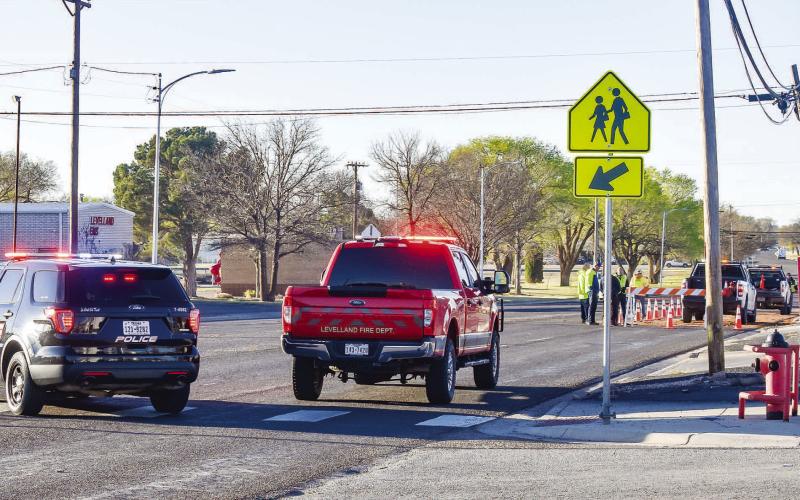DIVERTING TRAFFIC - On Wednesday morning, all southbound traffic on Avenue H was being diverted as Levelland Fire Department personnel and City of Levelland crew worked to clean leaking gasoline and hydraulic fluid that made its way on the road. Crews worked quickly to clean the spill as the fluids posed a threat of making it into the storm drain. (Staff photo by Emily Campos)