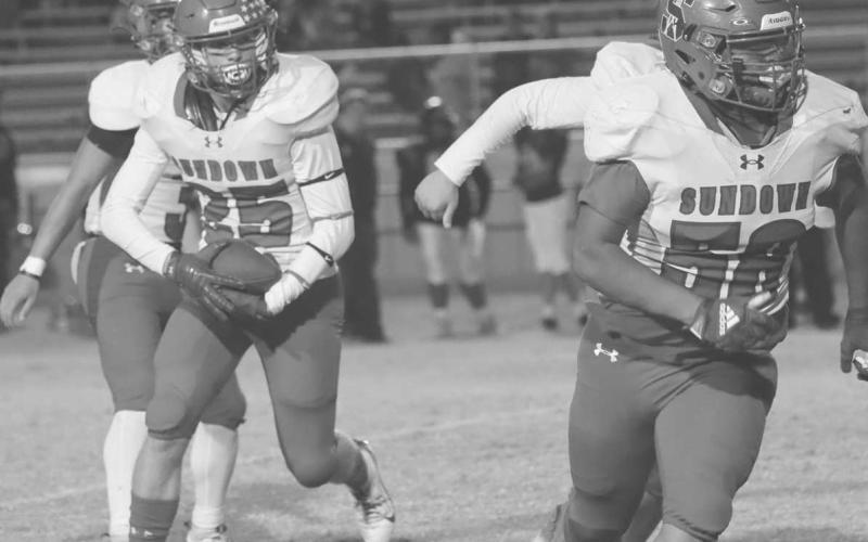 OUTSIDE RUN - Sundown Roughneck Trevor Bridges ran behind his lead blocker Brayden Longoria during the team’s game against the Plains Cowboys this past Friday on the road. (Photo courtesy of Sundown ISD)