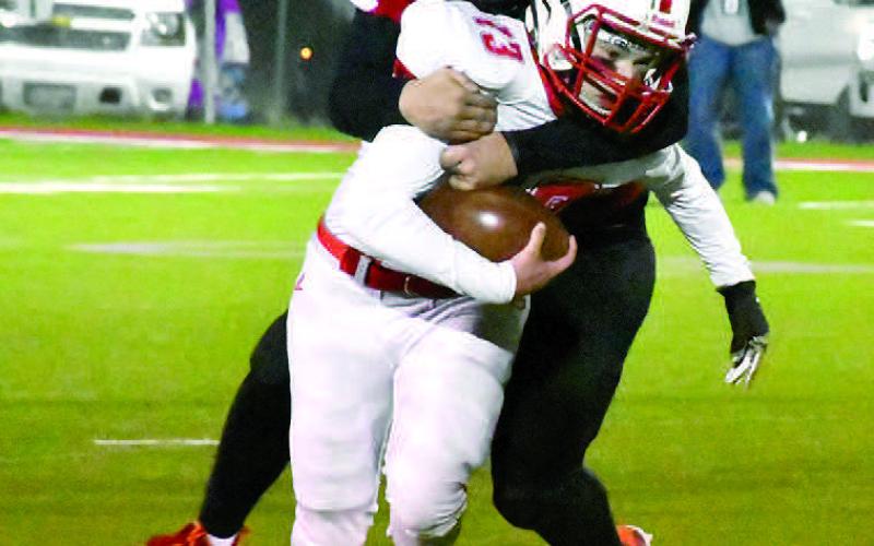 BACKFIELD TACKLE- Ryan McDaniel had 4 1/2 tackles, including this one for a loss in the Whitharral Panthers’ 46-0 win over the Silverton Owls in the Bi-District round of the UIL Class 1A-2 Region I high school football playoffs in Lockney last Friday. The Panthers will face Klondike next Friday in the area round at Trinity Christian School in Lubbock. Game time is 7 p.m. (Photo by Jay Kelley)