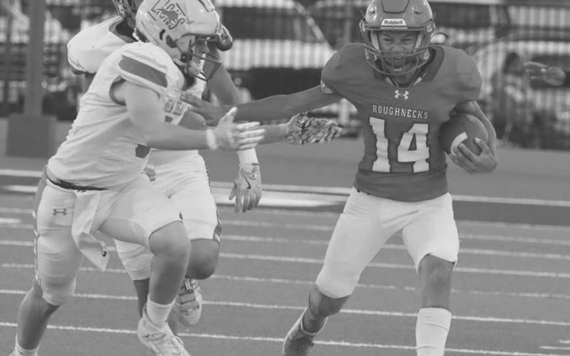 DOWN THE SIDELINE - Sundown Roughneck Ethan Morales ran down the sideline and threw a stiff arm to gain extra yards in the team’s homecoming game against the New Deal Lions at home. (Photo courtesy of Sundown ISD)