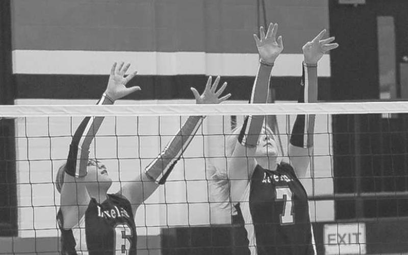 VERTICAL- Levelland Loboettes Hailiee Estrada and Addisen Campbell jumped high to block the Littlefield Lady Cats shot this past Tuesday at home. (Staff photo by Aalijah Soliz)