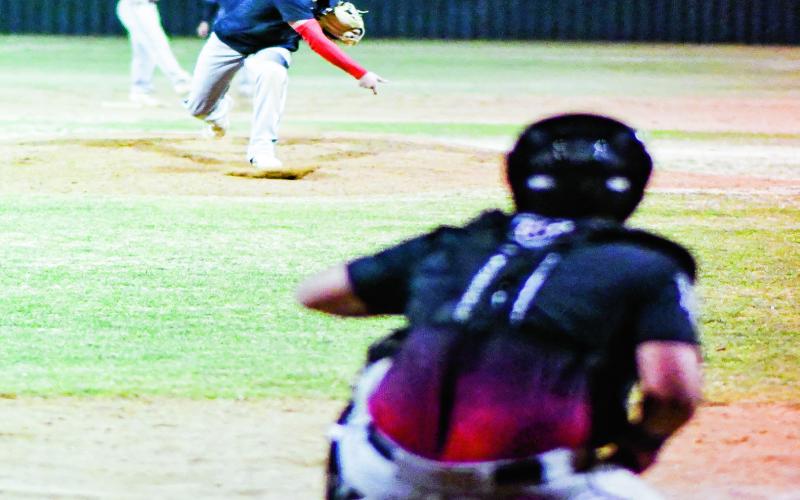 ARTEAGA ON THE MOUND - Levelland Lobo Abram Arteaga throws a pitch to the catcher from the mound in between innings during their scrimmage against Seminole this past Friday at Levelland High School. (Staff photo by Jentezen Smith)