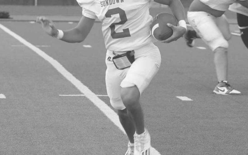 ELUSIVE - Sundown Roughneck Adan Escamilla escaped the pocket and looked to run downfield this past Friday against the Sudan Hornets for the team’s last scrimmage of the year. (Photo courtesy of Sundown ISD)