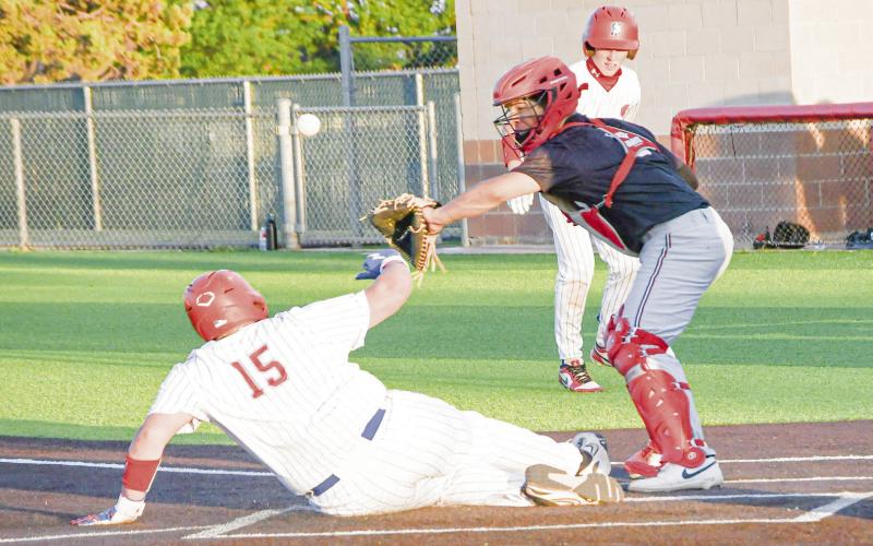HE’S SAFE! - Sundown’s Ollen Pearson slides into home plate and scores a run while the ball goes astray during their second game against Seagraves this past Tuesday night at Sundown High School. (Staff photo by Jentezen Smith)
