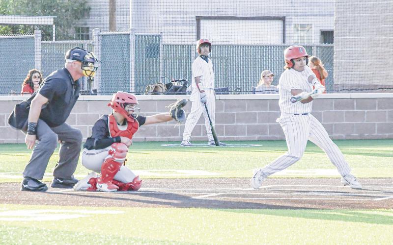 TAKE ME OUT TO THE BALLGAME - Sundown’s Gordon Mata squares up a pitch while the catcher and umpire closely watch this past Tuesday night at Sundown High School. (Staff photo by Jentezen Smith)