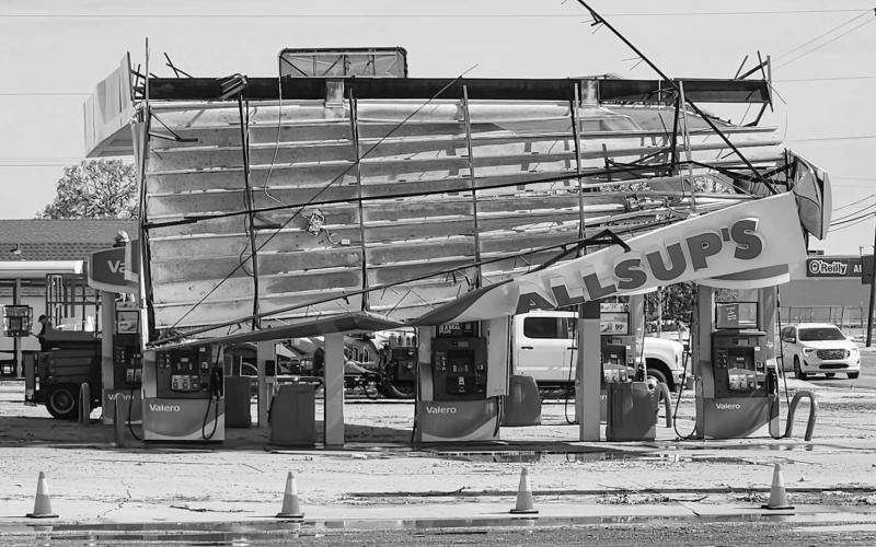 DANGEROUS SITUATION – Following Wednesday morning’s storm, various structures were partially or entirely collapsed which included the awning covering the gas pumps located at All-Sups in Levelland. A crew was sent to the connivence store Thursday morning to tear the remaining awning down safely. (Staff photo by Emily Campos)