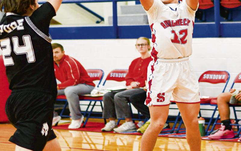 CARR FROM LONG RANGE - Sundown Roughneck Rylan Carr shoots a three-pointer during their home game against the Lubbock Titans this past Friday night. (Staff photo by Jentezen Smith)
