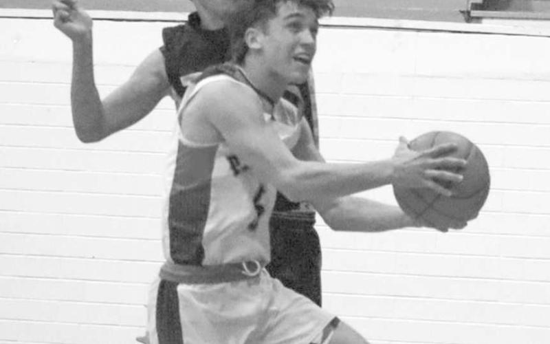 CANT STOP ME - Whitharral Panther Jack Griffin layed the ball up with Morton defender A.J. Mendoza right behind him for the block attempt. (Staff photo by Aalijah Soliz)