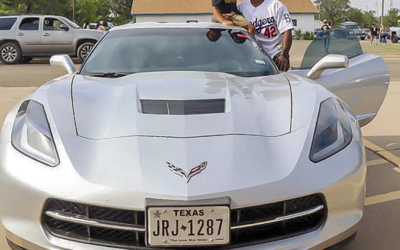 CHEVY STINGRAY- Dewey Childers and his son Jonah posed for a picture beside their 2014 Chevy Corvette Stingray during the car show at the 33rd annual Juneteenth Celebration Saturday, June 16th at