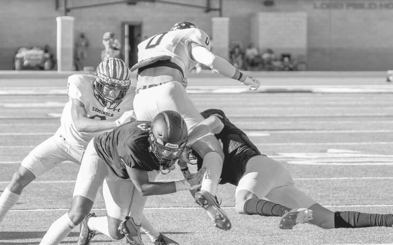SECURE TACKLING - Two Levelland Lobos tackled a Seminole wide receiver in the open field this past Friday at home for their first scrimmage of the year. (Staff photo by Dom Puente)