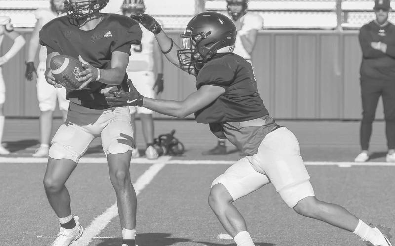 HANDOFF - Levelland Lobo Boston Winfield handed the ball off to Ricky Rodriguez this past Friday during the team’s scrimmage against Seminole at home. (Staff photo by Dom Puente)