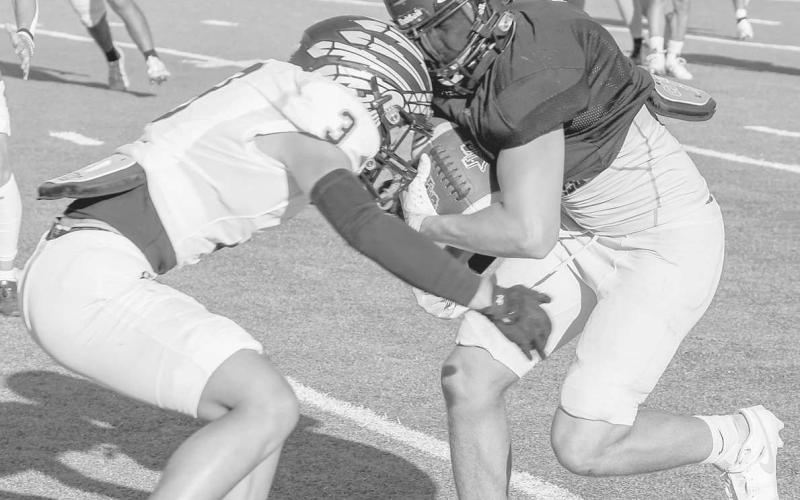PHYSICAL - Levelland Lobo Kaden Brogden ran through his defender this past Friday during the team’s scrimmage against the Seminole Indians. The teams next scrimmage is against the Big Spring Steers this Thursday as the away team. (Staff photo by Dom Puente)