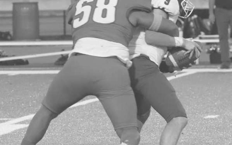 SACKED - Sundown Roughneck Brayden Longoria sacked Smyer Bobcat Skyler Pond last Friday in both team’s district opener. (Photo courtesy of Sundown ISD)