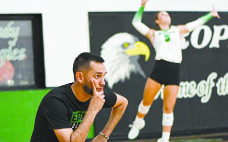 LOCKED IN – Ropes Volleyball Head Coach Jon Montanez watches intently while Braedyn Reyna makes the serve during a game against Wellman Union this past Tuesday at the Ropes School. (Jentezen Smith)