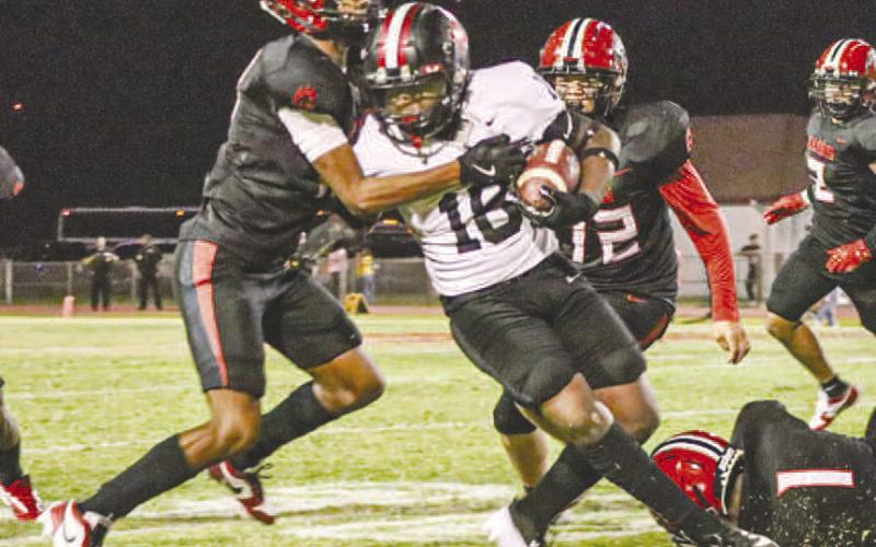 TOUGH RUNNING - Levelland Lobo Noah Martin ran through one Brownfield defender to meet another one past the line of scrimmage this past Friday against the Brownfield Cubs. (Staff photo by Aalijah Soliz)