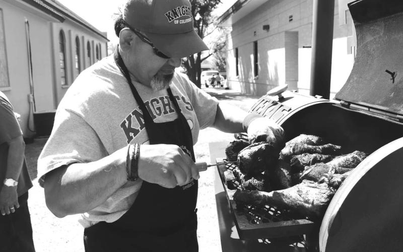 TURKEY LEGS- St. Michael’s Catholic Church had it’s 2024 Annual Jamaica on September 15. Pictured is Freddy Ruiz smoking turkey legs for the Jamica. (Photo courtesy of Emily Campos)