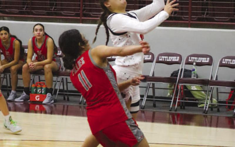 FINISH HARD - Levelland Loboette Presley Smith layed the ball up through contact from the Denver City defender at the Littlefield Tournament. (Staff photo by Aalijah Soliz)