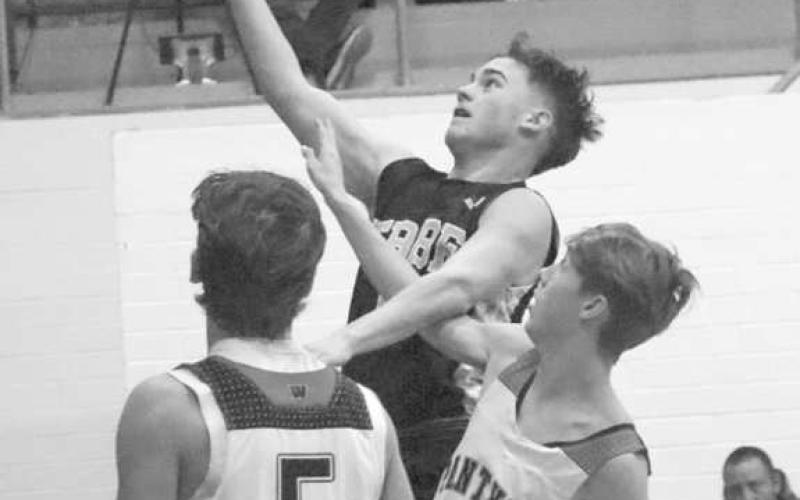 CONTESTED - Morton Indian Lane Lyon layed the ball up through the contact over Whitharral Panther Landon Lee to get the and one attempt last Tuesday. (Staff photo by Aalijah Soliz)