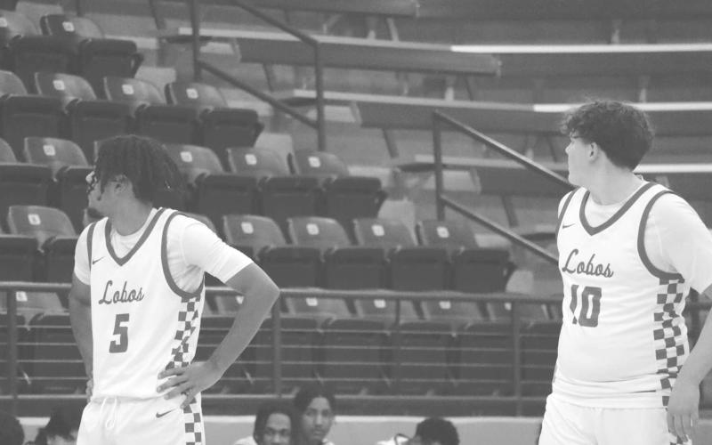 DUO - Levelland Lobos Sean Landrum and Graham Gibbs listened to Head Coach Jordan Windholz as their team shot free throws against the Bushland Falcons in the Littlefield Tournament last week. (Staff photo by Aalijah Soliz)