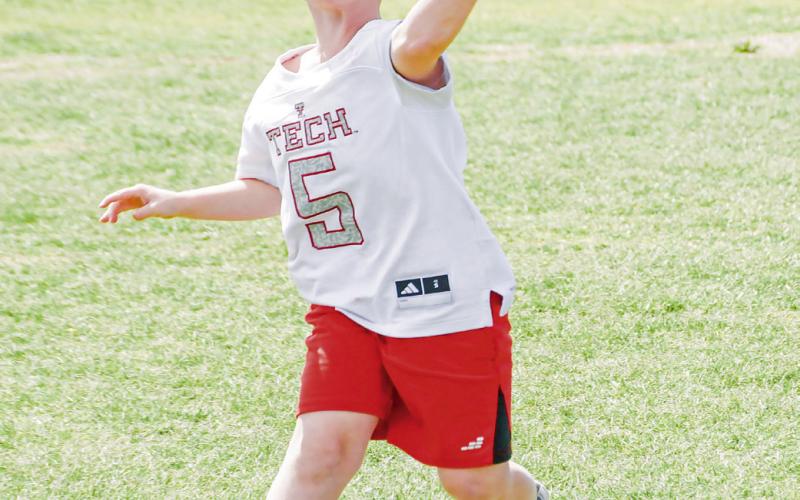 MINI MAHOMES - Bobcat camper Jackson Hodges makes a throw on the run in his Patrick Mahomes Texas Tech jersey during their football session at Smyer High School. (Staff photo by Jentezen Smith)