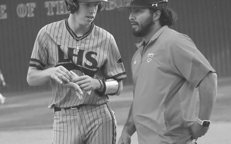 WHATS NEXT - Levelland Lobo Anson McMahan talked to his Coach Brandon Coronado during the team’s game against the Sweetwater Mustangs this past Tuesday at home. (Staff photo by Aalijah Soliz)