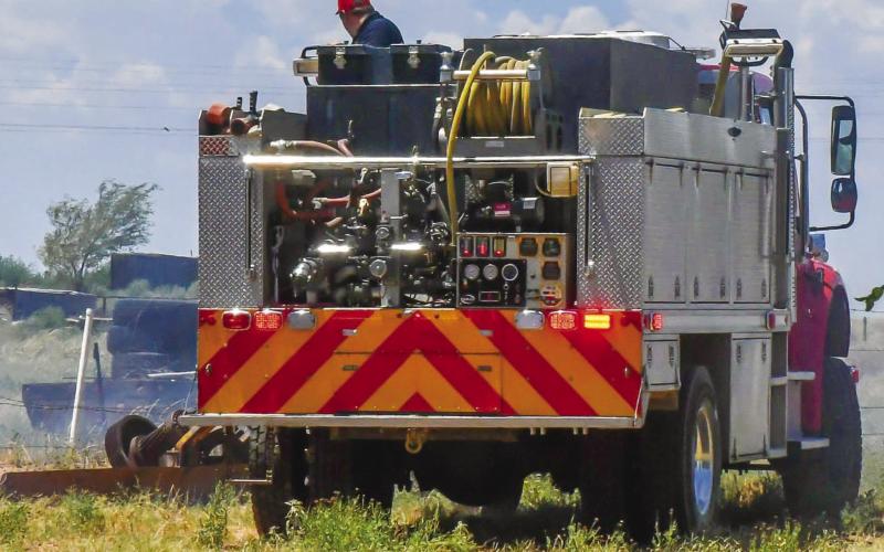 PRIME GRASS FIRE CONDITIONS - With large amounts of fuel loading scattered around the West Texas area, extreme temperatures have increased the likelihood of grass fires starting. Low humidity and increased wind speeds are two key factors in grass fires and fire departments across the region are advising citizens to burn debris cautiously. Pictured is the Levelland Fire Department responding to an out of control pit fire that reached grass areas Saturday. (Staff photo by Jay Kelley)