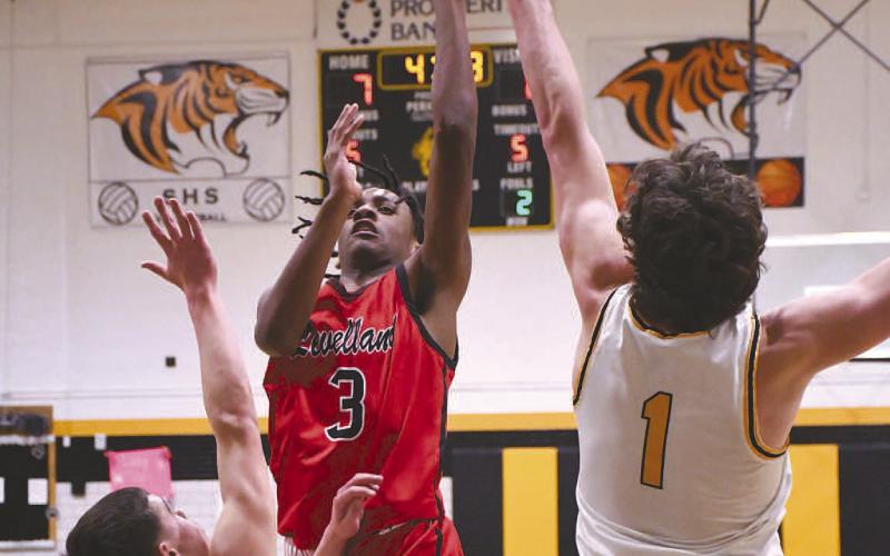 TOUGH TWO- Lobo Eryk Jones put up a shot over two Snyder defenders. Levelland came up short on the road in Snyder 49-43.The loss moved the Lobos to 13-13 overall and 3-2 in district. Levelland will host Estacado Friday. (Staff Photo by Dom Puente)