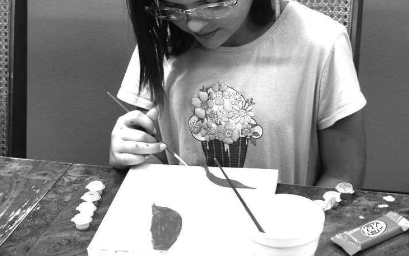 PAINTINGBYNUMBERS - At Capitol Elementary this past Tuesday Jazmin Marryfo enjoyed painting a beautiful piciture on canvaes. Jazmin is one of the Kid w/character award winner this nine weeks. (Staff photo by Emily Campos)