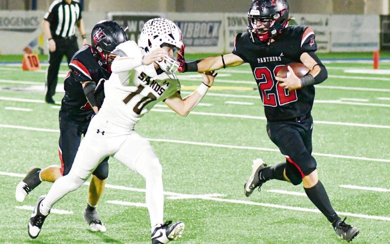 1A-2 DISTRICT 3 OFFENSIVE MVP - Whitharral senior running back Greg Johnson rushes the football and stiff arms a Sands defender during their playoff football game earlier this month in Lubbock. Johnson would end the season with 1,844 rushing yards and 37 touchdowns, which earned him the honor of 1A-2 District 3 Offensive MVP. (Staff photo by Jentezen Smith)
