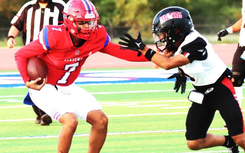Sundown Roughneck prepares to defend ball agaisnt Seagraves defensive player. (Sundown ISD photo)