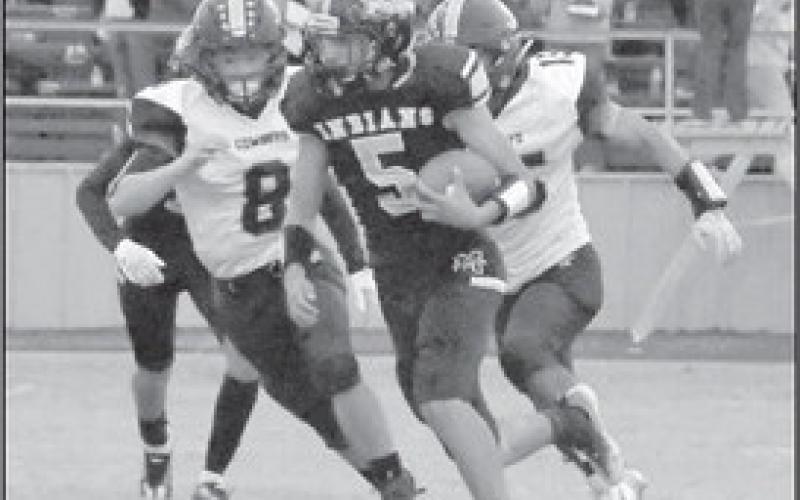 IN PURSUIT- Morton’s Alex Lopez was pursued by Plains defenders in a 22-2 Morton home loss to open UIL Class 2A-2 Region 1, District 4 high school football action. The Indians will be in Ropes on Friday night to face the Eagles at 7 p.m. (Photo Courtesy of Jay Kelley)