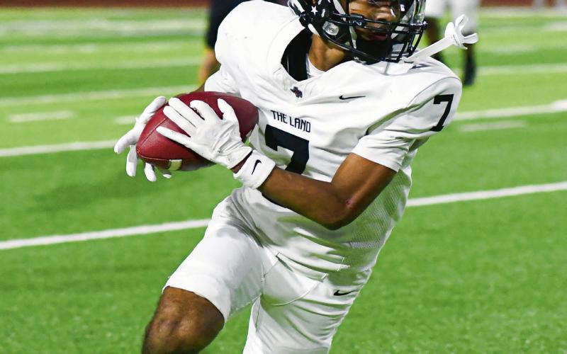 ADD UP THE “YAC” - Levelland sophomore wide receiver Bryson Golightly catches a pass and goes for more yards after the catch during their playoff football game against Seminole this past Friday at Frenship High School. Golightly would have several similar efforts to end with four catches for 80 yards and a receiving touchdown, along with a rushing touchdown. (Staff photo by Jentezen Smith)